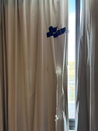 Torn curtains held together with duct tape