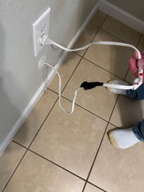 Spliced wire with electrical tape coming out of wall