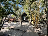 Shaded boardwalk path among the rooms
