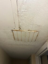 This was a panel in the ceiling that was located near the rusted air vent. It was dripping water from it onto the carpet below informed the front desk about it, and was told they would tell maintenance about it.