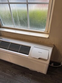 Dirty windows. Look at wall around AC and window