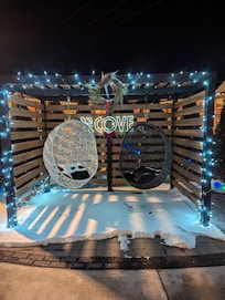 Outdoor seating area with fire pit and grill area.