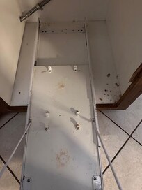 The garbage pull out drawer when we arrived, covered in crumbs.