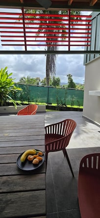 Covered patio with seating, mini fridge and outdoor sink