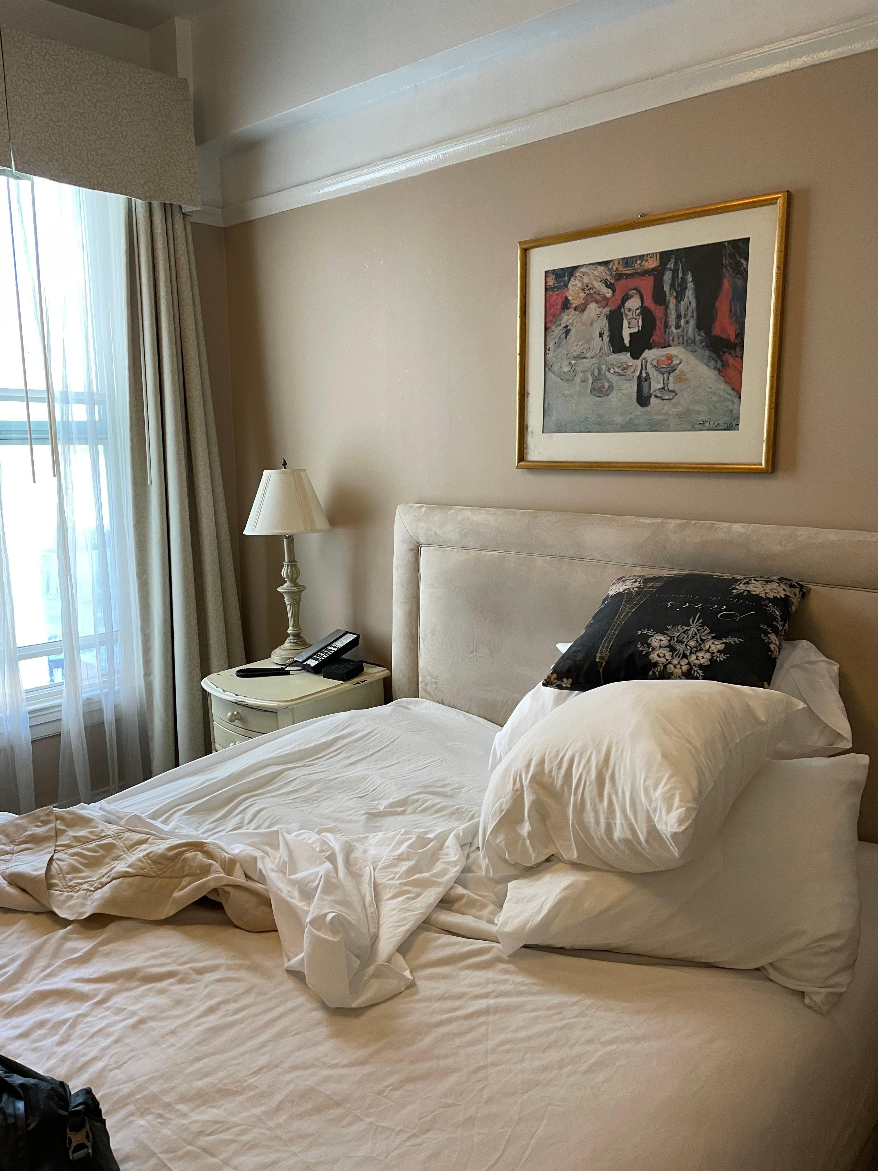 Bed, window, and art. 