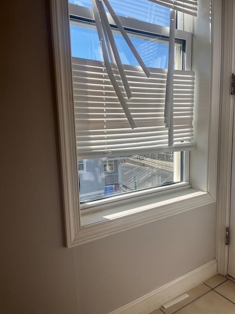 View of the bathroom window gaps from the toilet area.