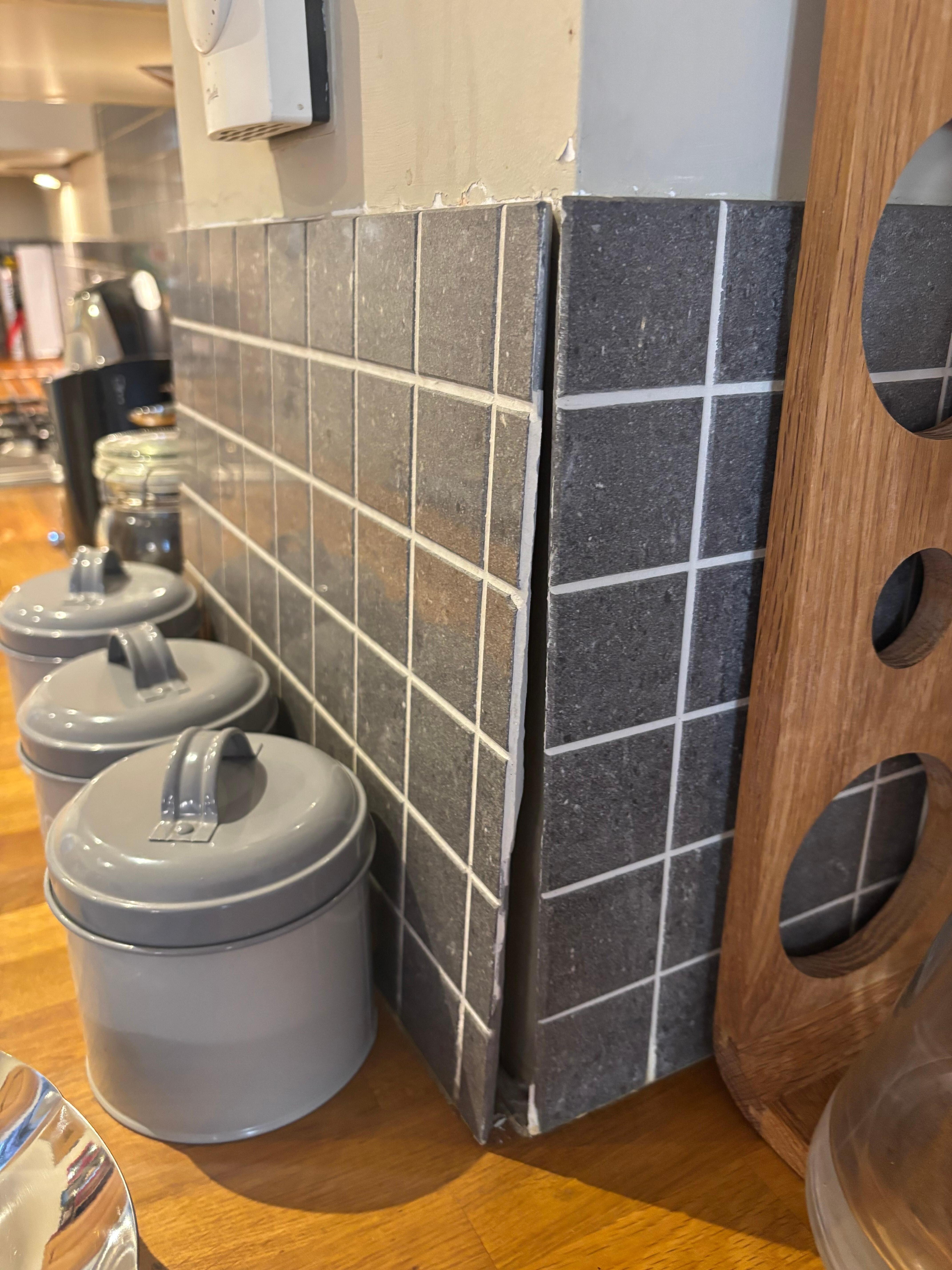 Broken tiles in dirty kitchen 