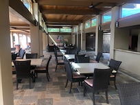 Covered area with kitchen by pool. Bathrooms.