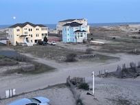 Wild horses across the street and the pink moon, from our balcony.