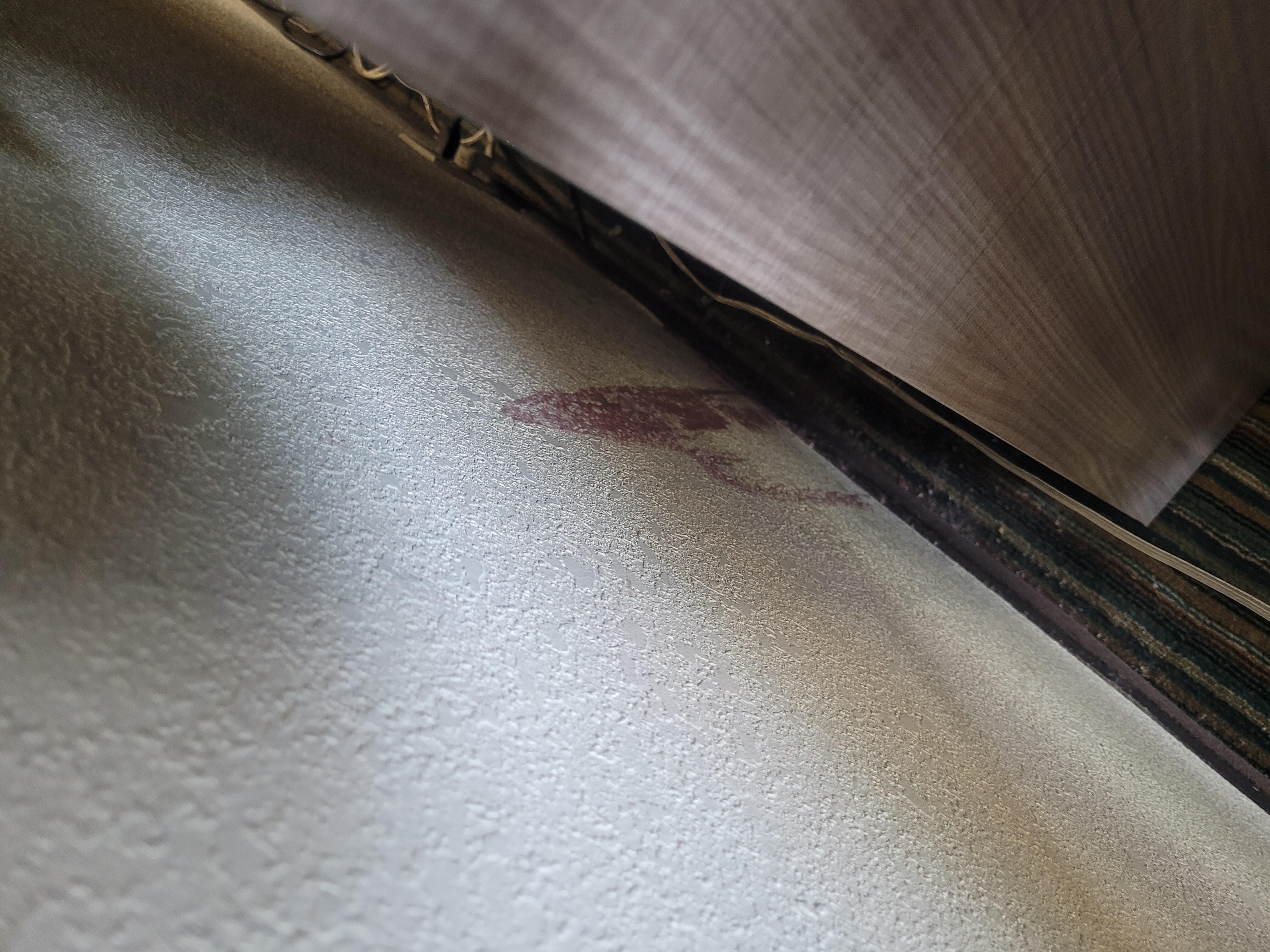 Stain on wall behind dresser
