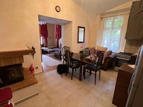 Large kitchen with eat in table and a couch under window to sit and chat with cook