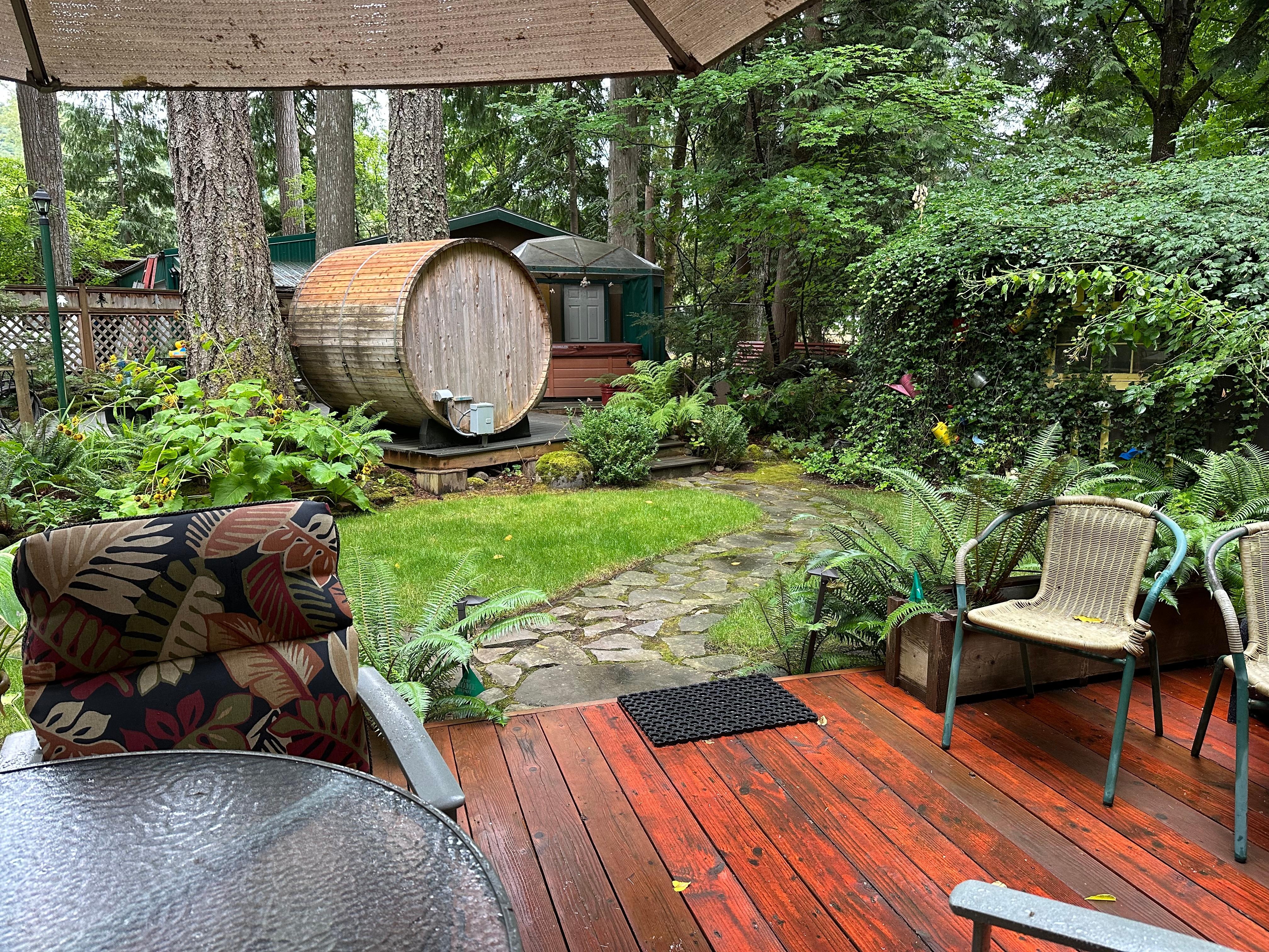 The back porch is the perfect place to relax. Hot tub and sauna in the background. 