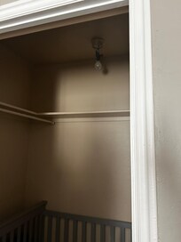 Closet off master with crib. No light cover.