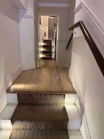 "Up, down, up" steps to the lift from the front building door. Lift door visible at the end.