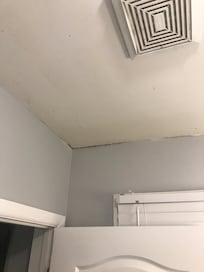 Black mold on ceiling and dirty fan that doesn't work.