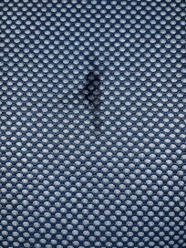 Stained cushion on corner sofa.