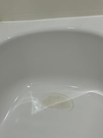 Stains in back of tub