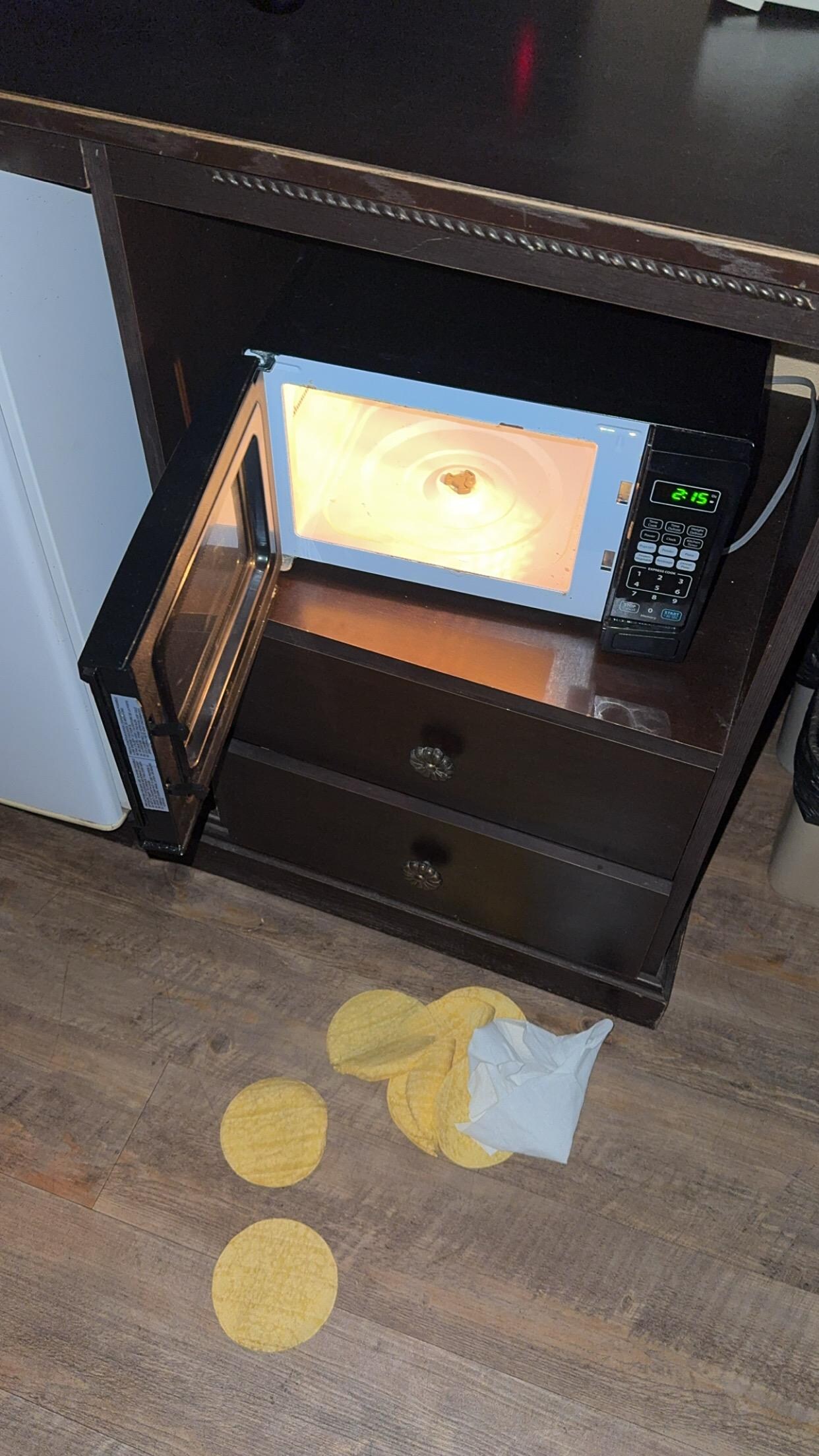 I opened the microwave and it was wrapped in paper towels I took it out to throw away and it fell