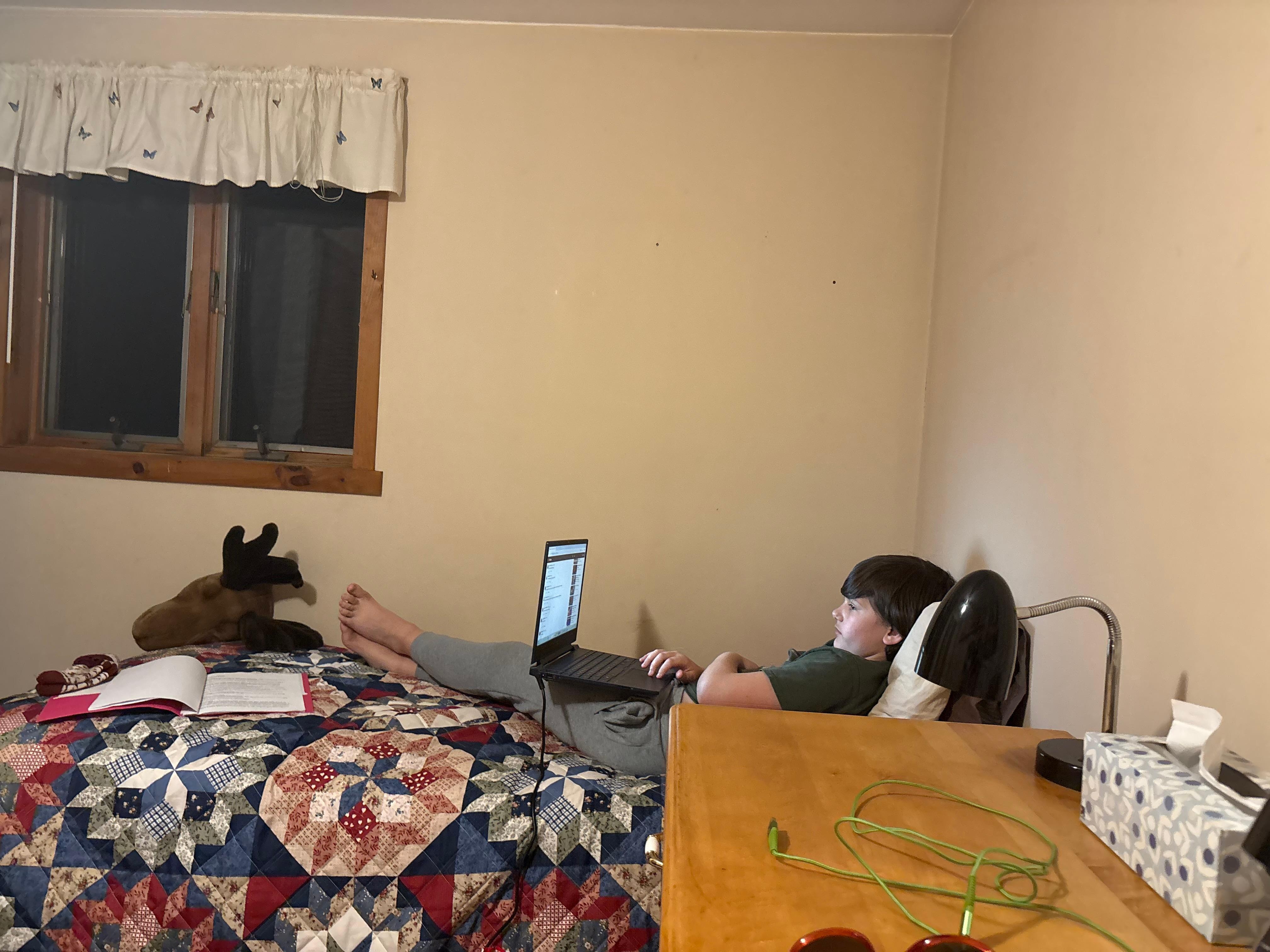 My youngest relaxing with moose head decor.