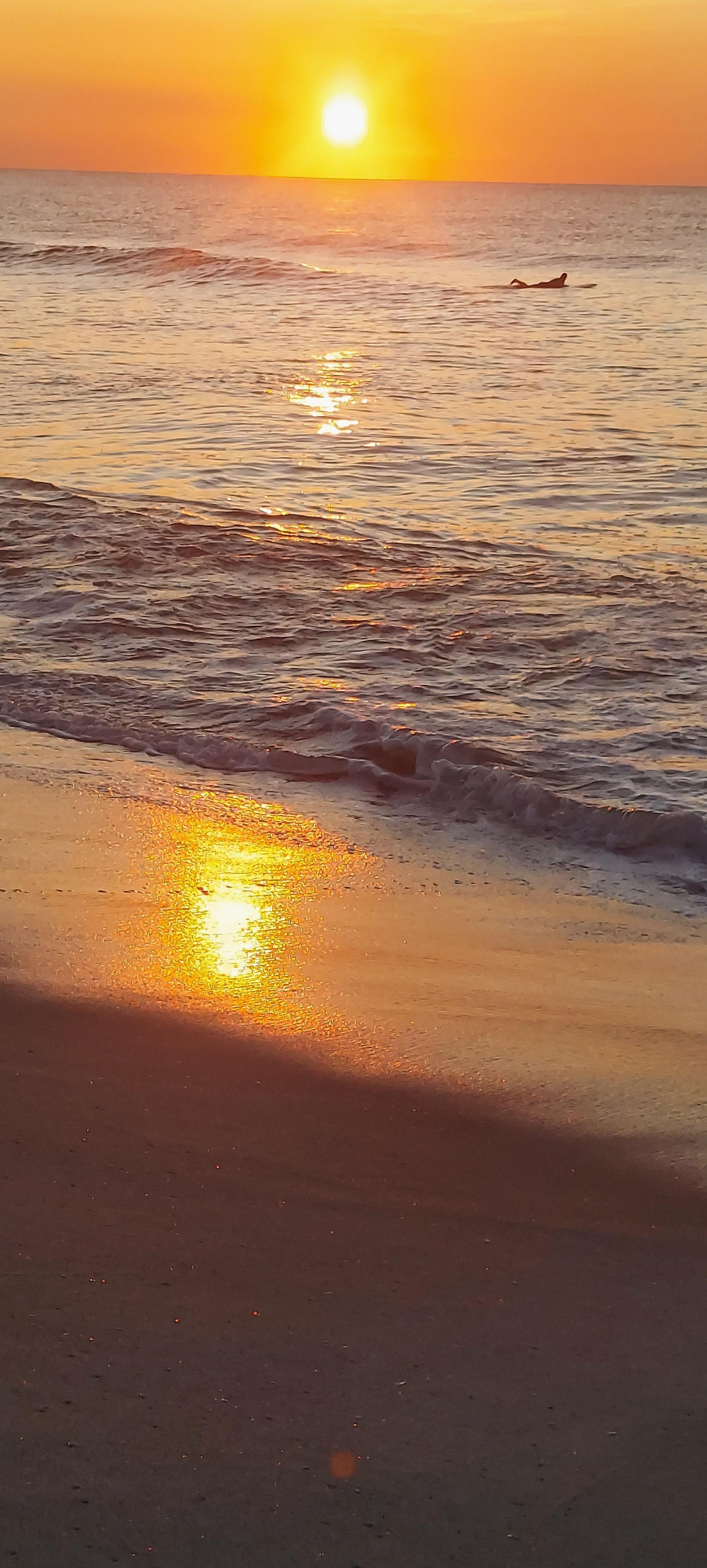 Sunrise and surfer near VRBO