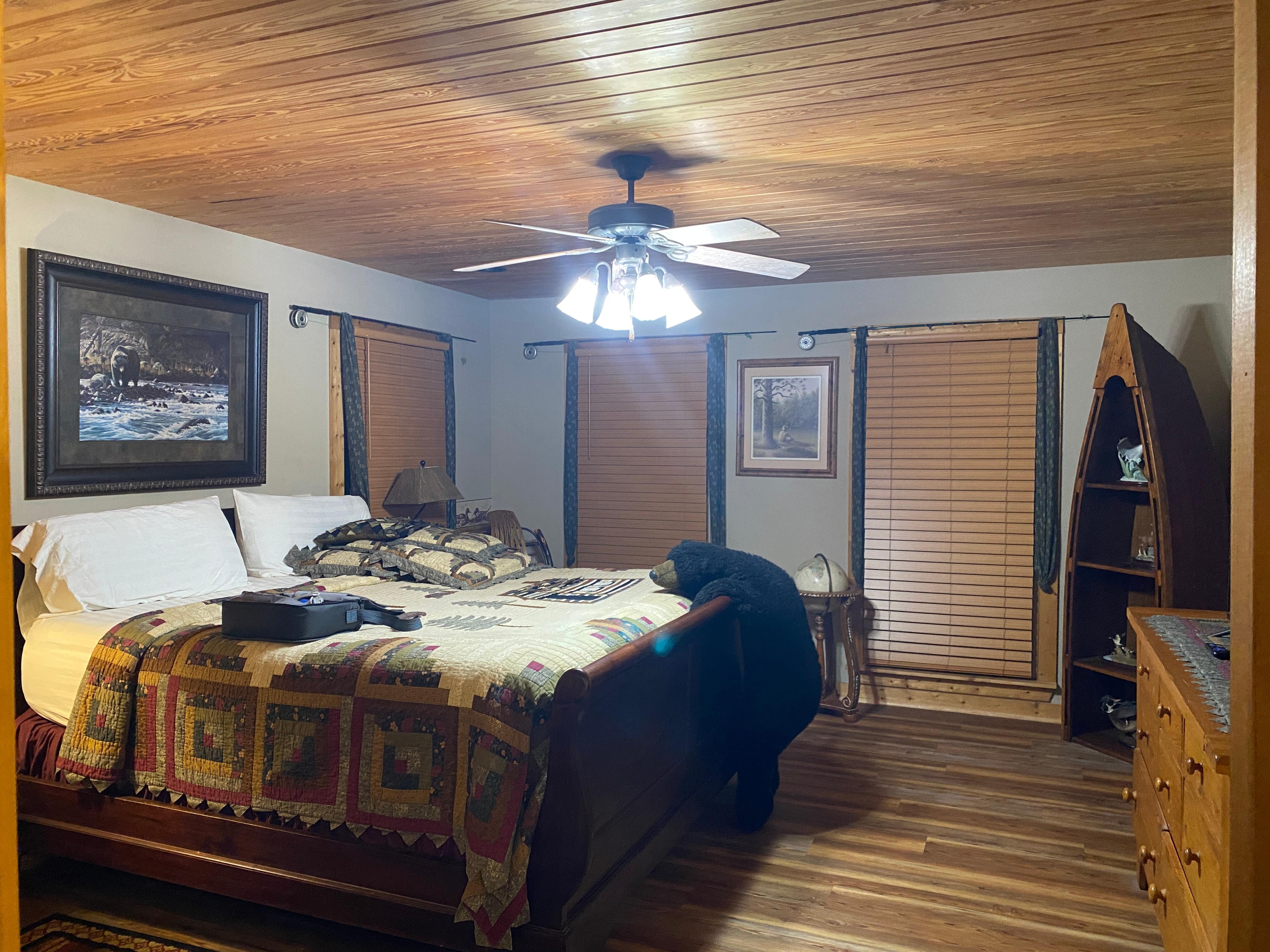 Comfortable bed in large master bedroom with large attached bathroom 