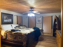 Comfortable bed in large master bedroom with large attached bathroom