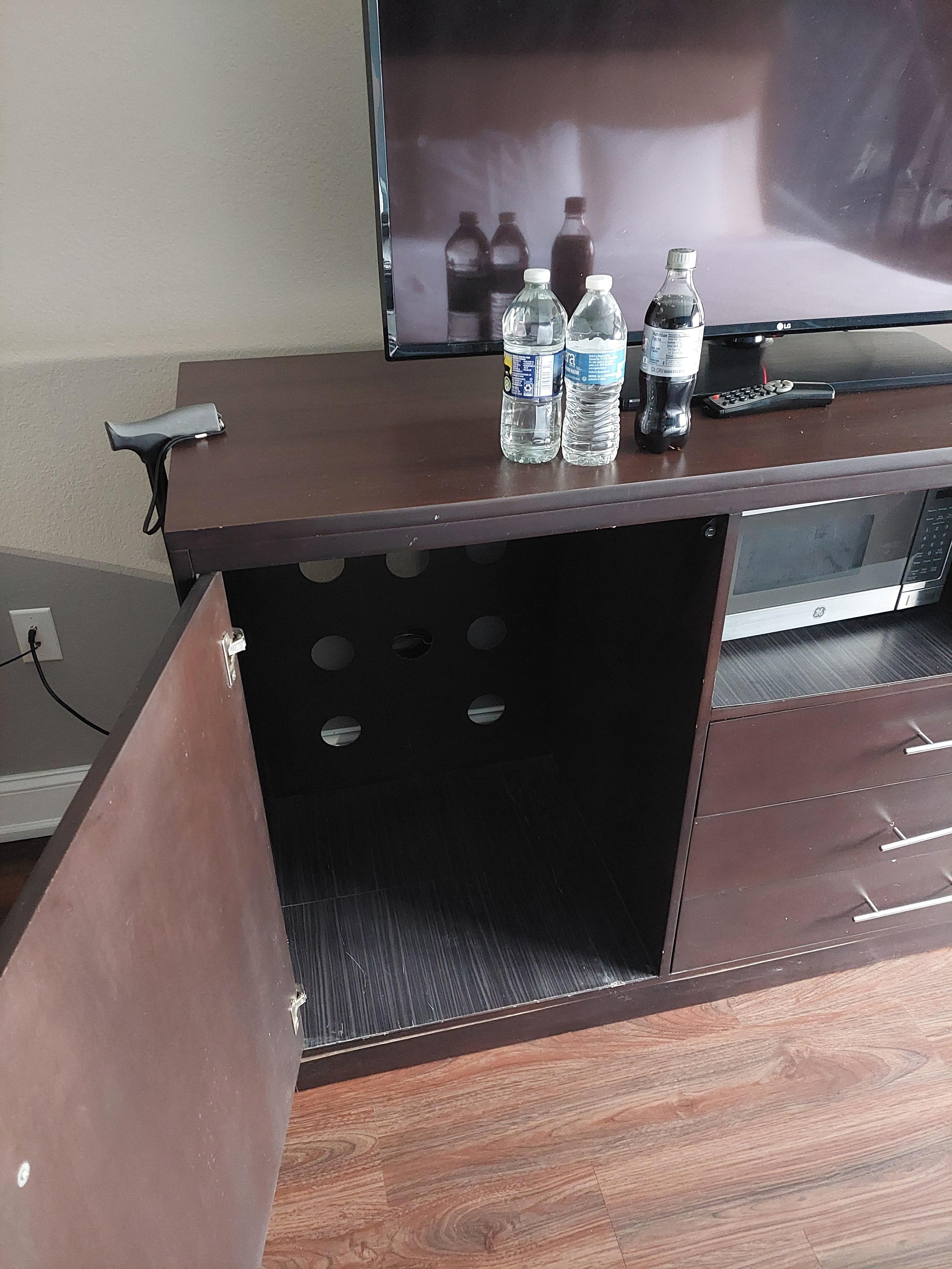 The spot where the missing refrigerator is supposed to be.