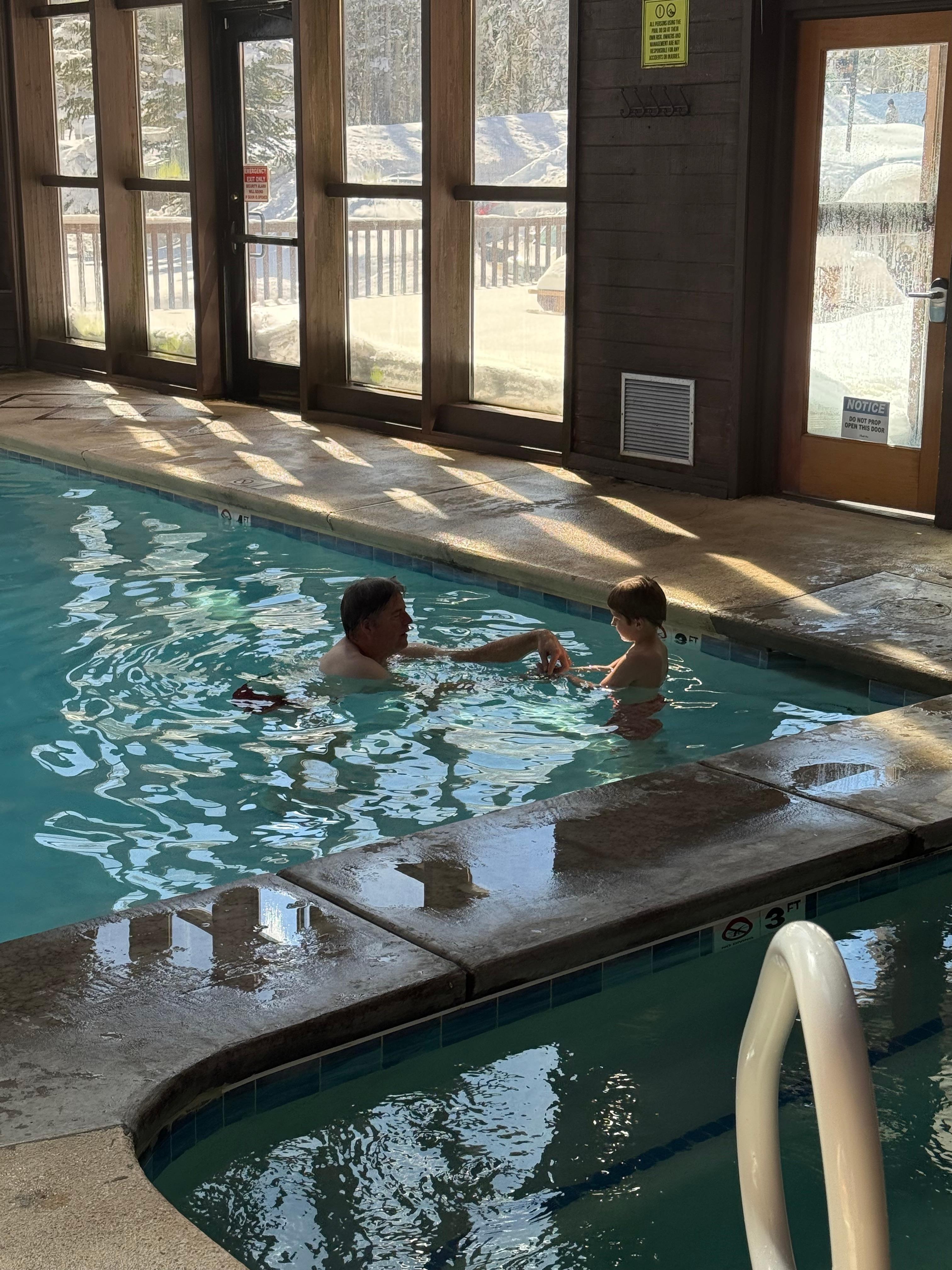 Enjoying the indoor  pool surrounded by trees and snow