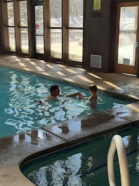 Enjoying the indoor pool surrounded by trees and snow