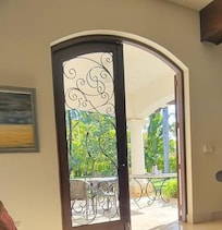 Wrought Iron w/o barrier between inside and outside. This is the back door. Front was the same.