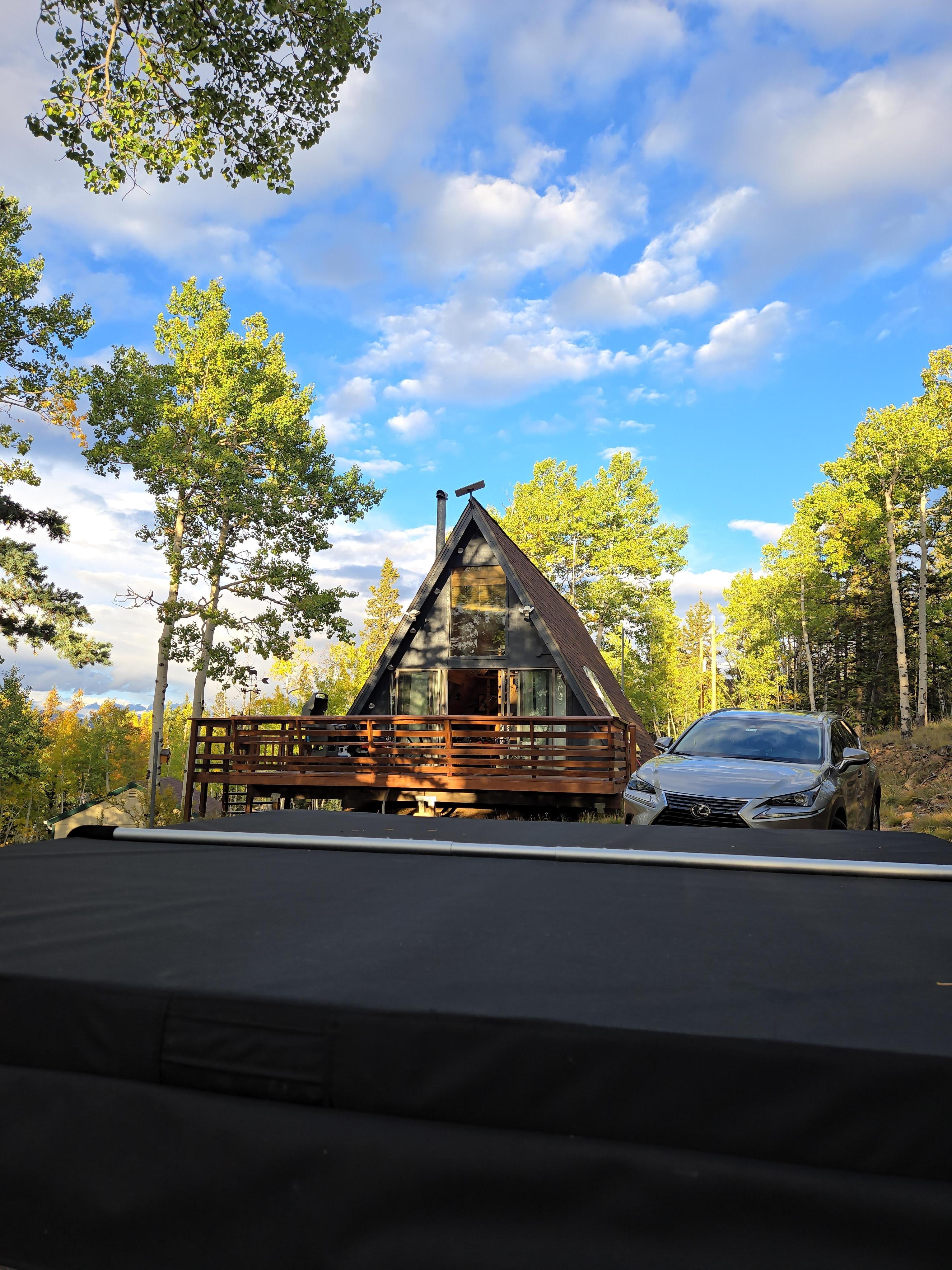 Beautiful view of the cabin with a circular driveway