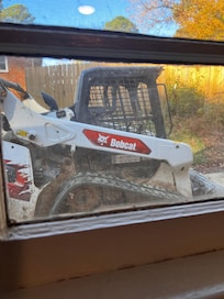 Contractors outside the bedroom & living room windows