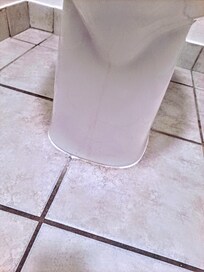Urine running down front of toilet and on floor