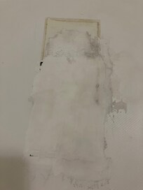 Sticky, ugly residue on floor of bathtub.