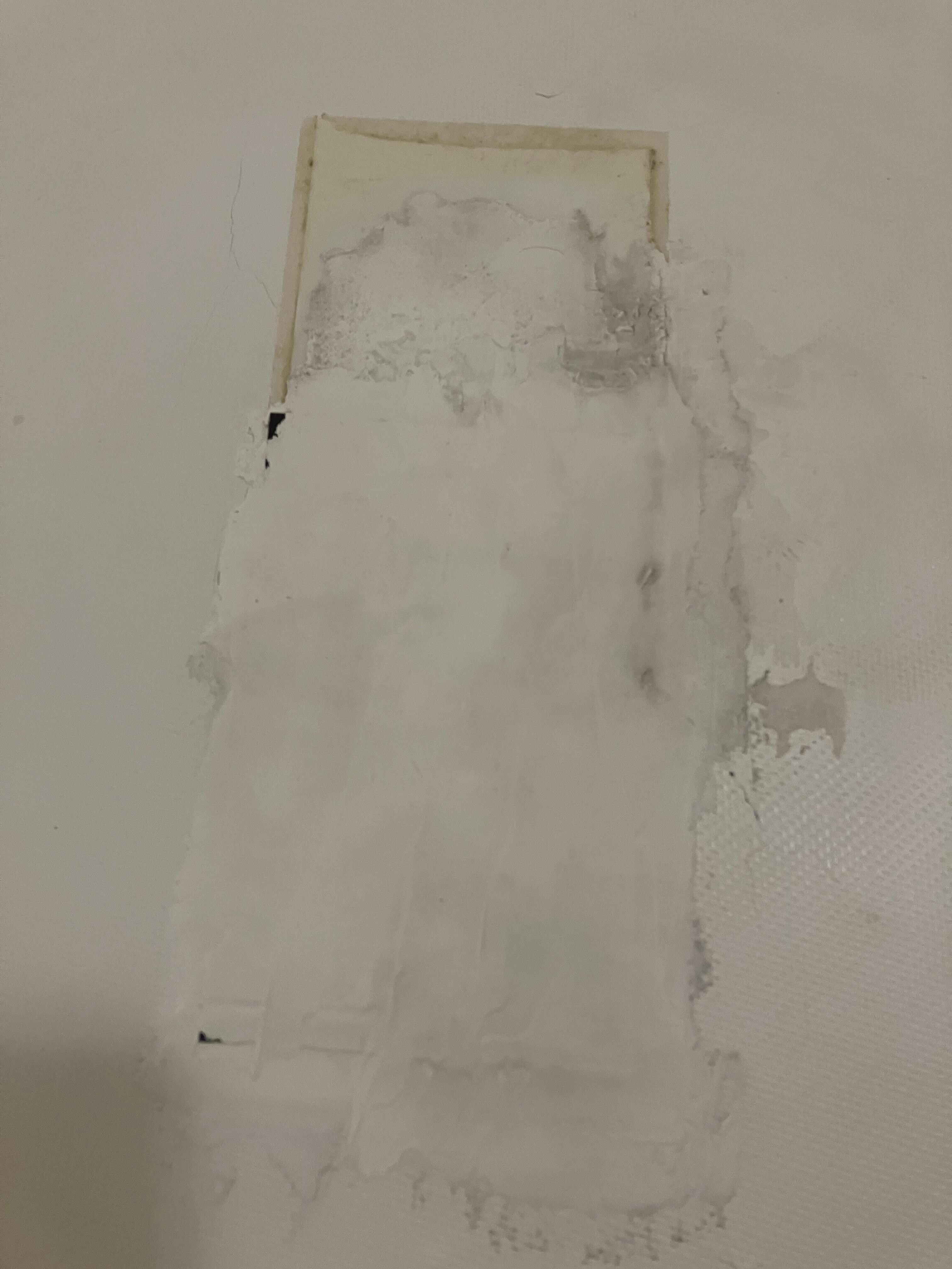 Sticky, ugly residue on floor of bathtub.