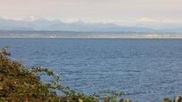 View of the Cascade range across the water and mainland.