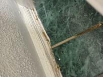 Dirty toilet area and warped baseboards