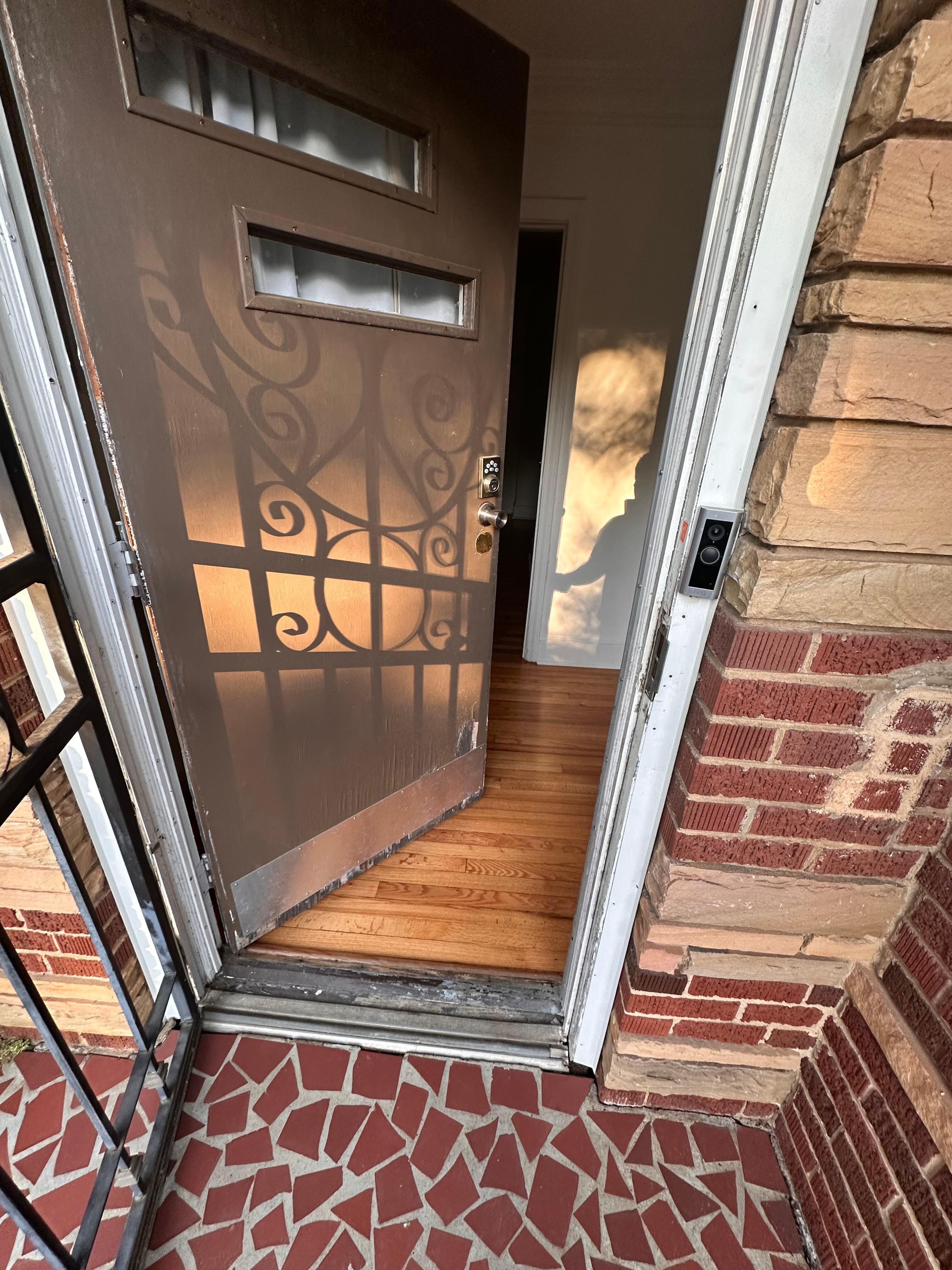 Larger picture of the thin front door that had been kicked in.