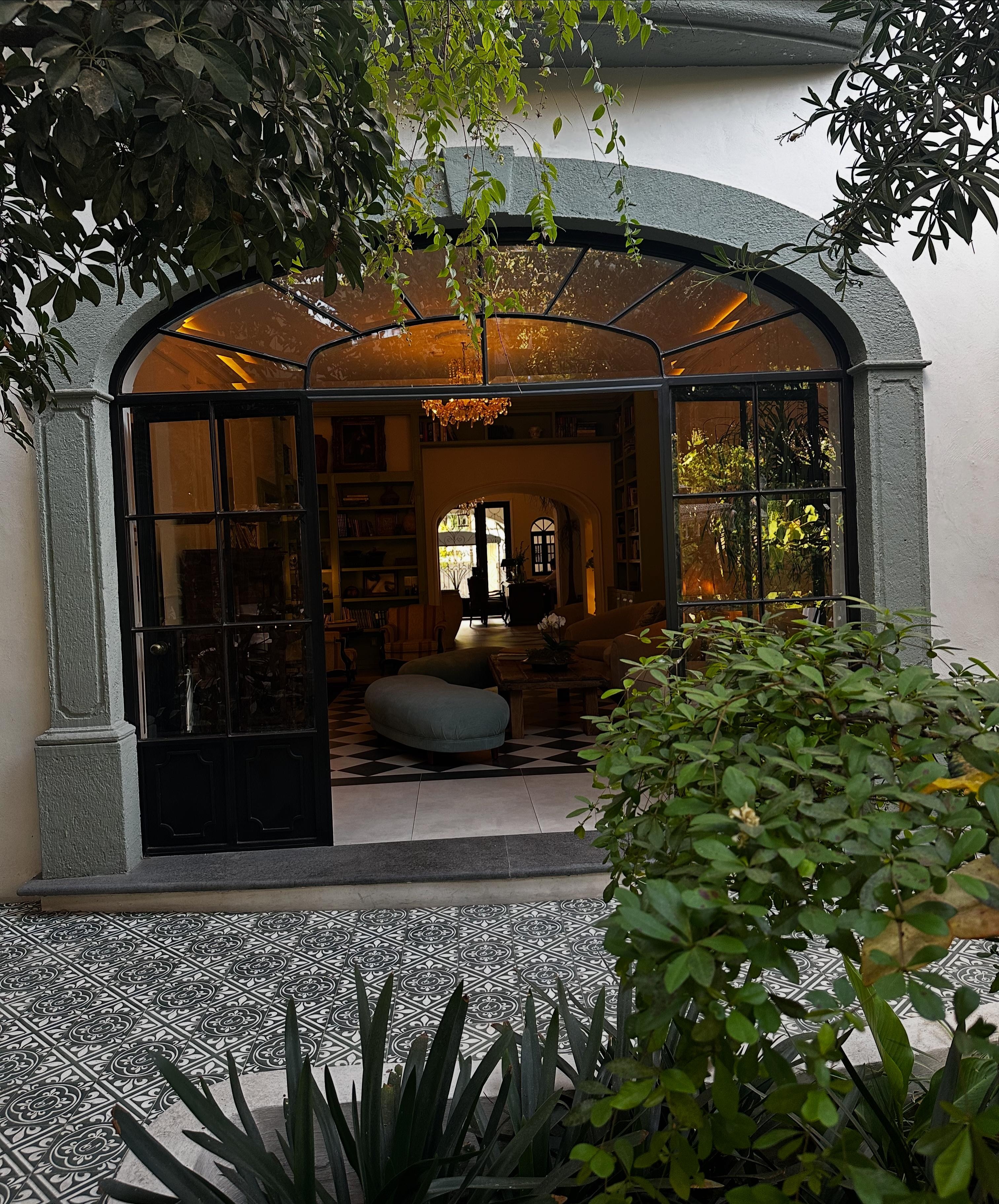 The entrance from the courtyard—oh so lovely to admire while sitting in one of the dining areas. A truly charming view that adds to the experience.