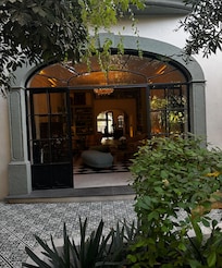 The entrance from the courtyard—oh so lovely to admire while sitting in one of the dining areas. A truly charming view that adds to the experience.