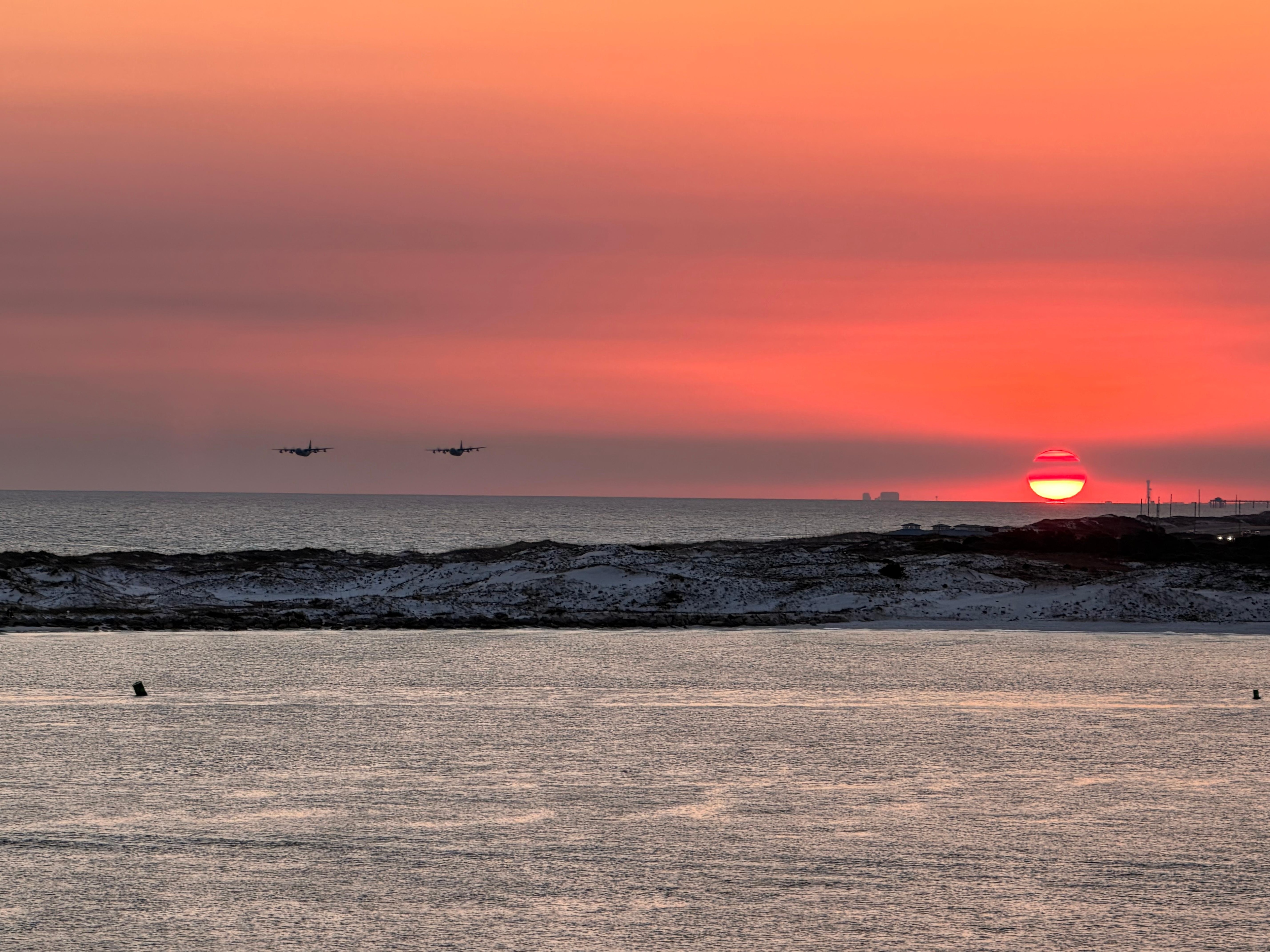 Sunset off the deck with 2 C130’s flying towards us.