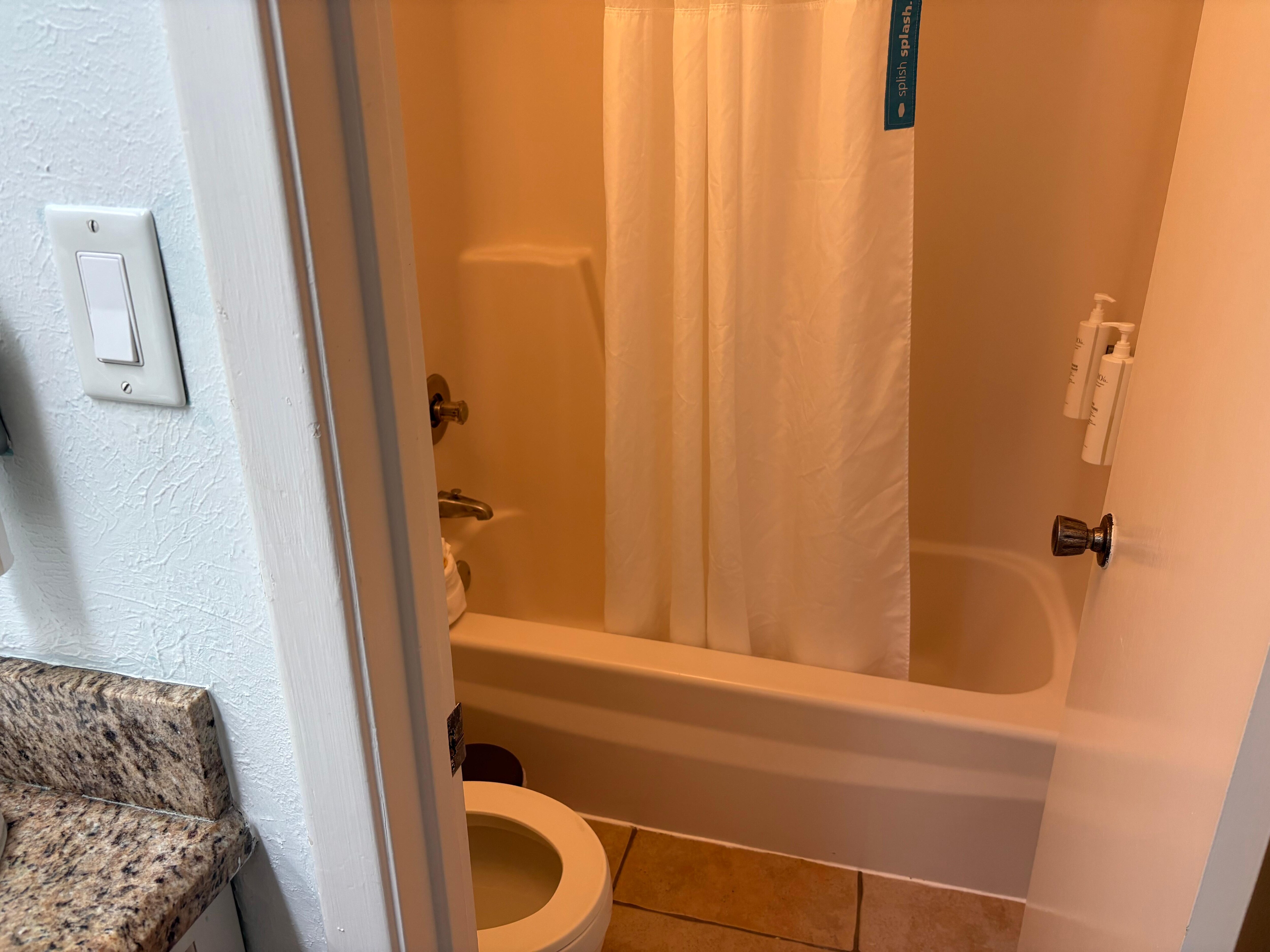 Toilet and shower in separate space with a door for privacy