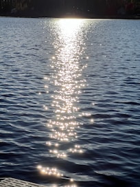 Shimmering lake sunset. Diamonds on the water.