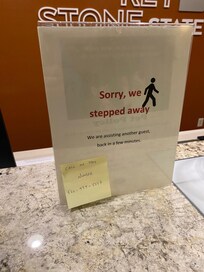 This sign was at the desk the entire visit. They were not assisting anyone. The person was in the back talking on his cell phone.