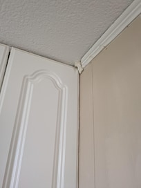 There was wadded up paper towel between the cupboard and the ceiling in the kitchen.