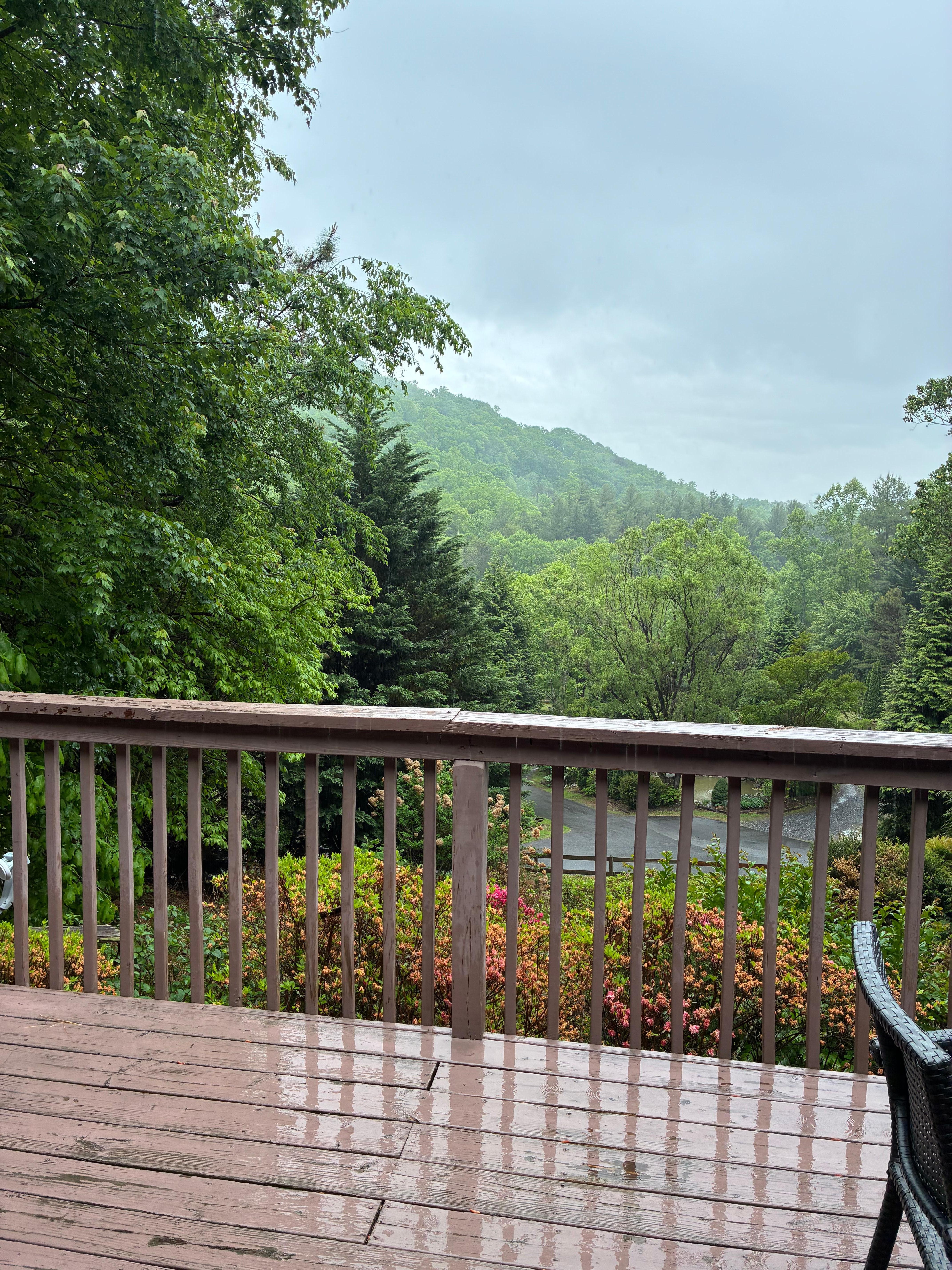 Standing in double door opening off main room looking outside to front porch and view. 