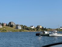 The cottage from across the harbour (the White House in the center)