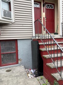 Garbage beneath entry stairs