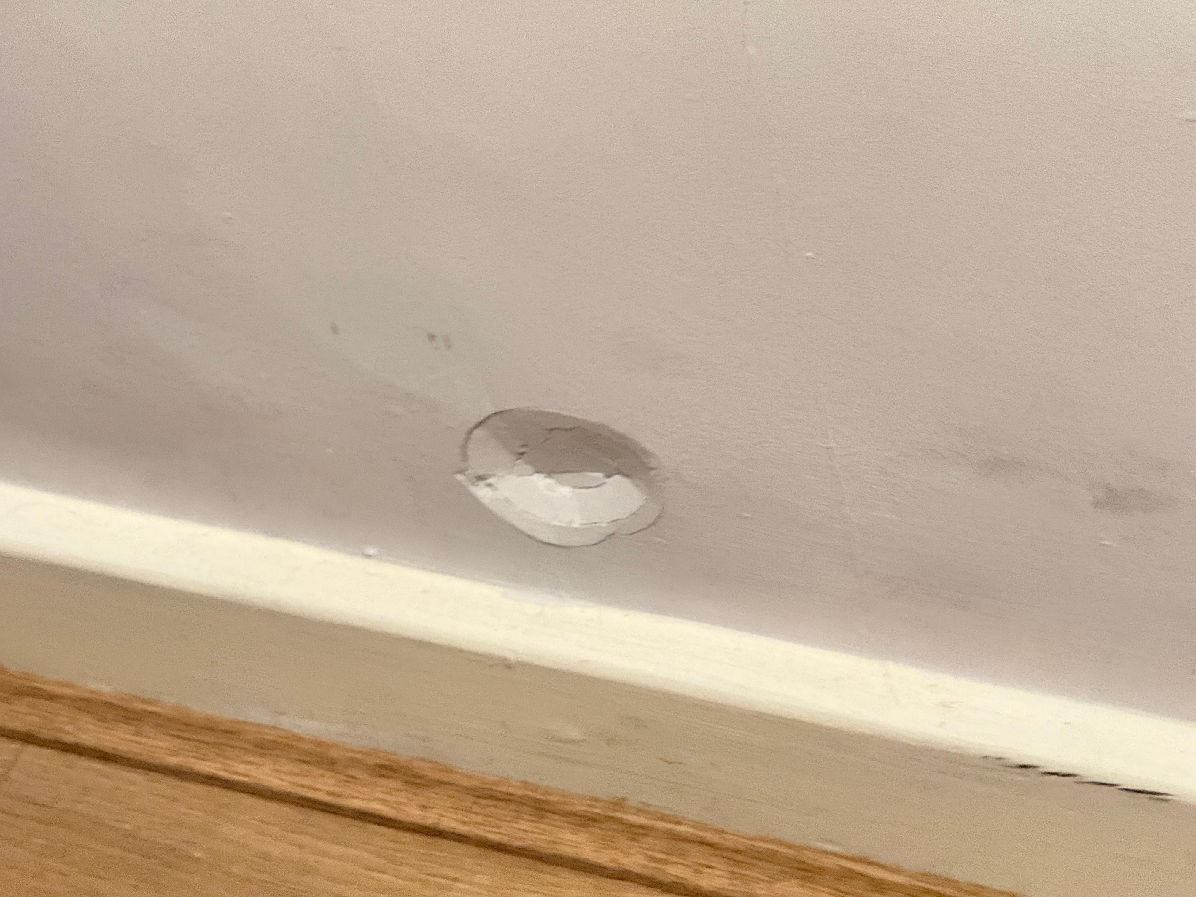 Dent in wall by bed 🙁