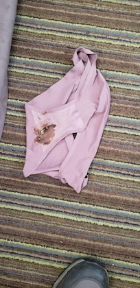 Soiled dirty underwear found under queen bed.
